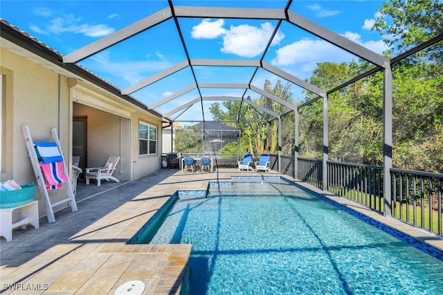 view of swimming pool with a fenced in pool, glass enclosure, and a patio