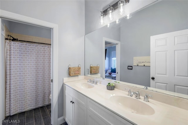 full bath with double vanity, toilet, a sink, and a shower with shower curtain