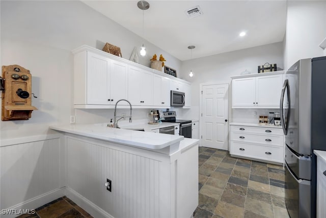 kitchen with visible vents, white cabinets, stone finish floor, appliances with stainless steel finishes, and a sink