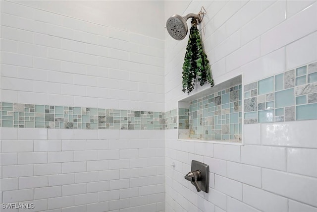 interior details featuring tiled shower