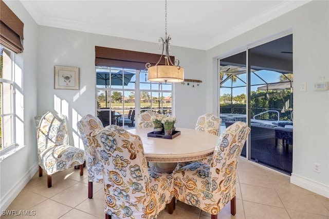 dining area with ornamental molding and light tile patterned flooring