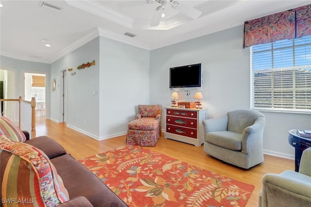 living room with ceiling fan, light hardwood / wood-style floors, and ornamental molding