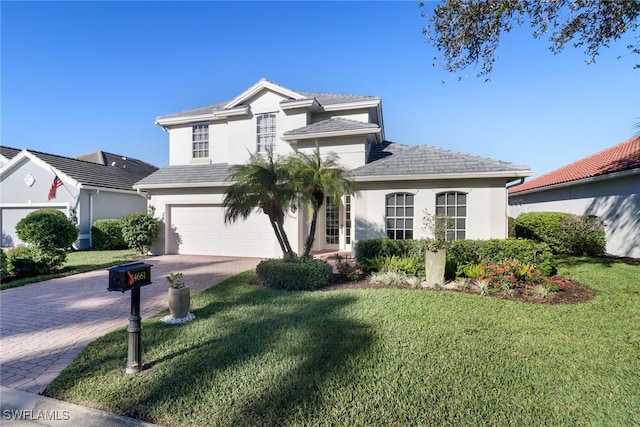 view of front of property with a front lawn and a garage