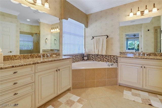 bathroom featuring ceiling fan, tile patterned flooring, shower with separate bathtub, vanity, and ornamental molding