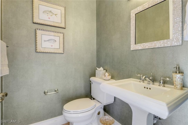 bathroom featuring sink and toilet