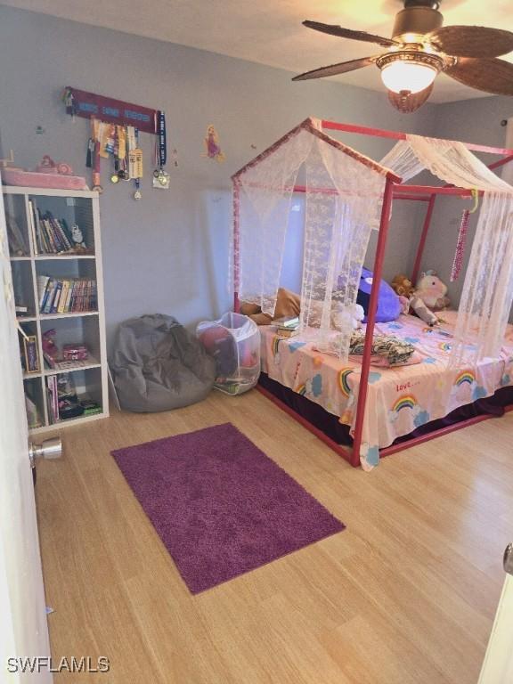 bedroom with hardwood / wood-style floors and ceiling fan