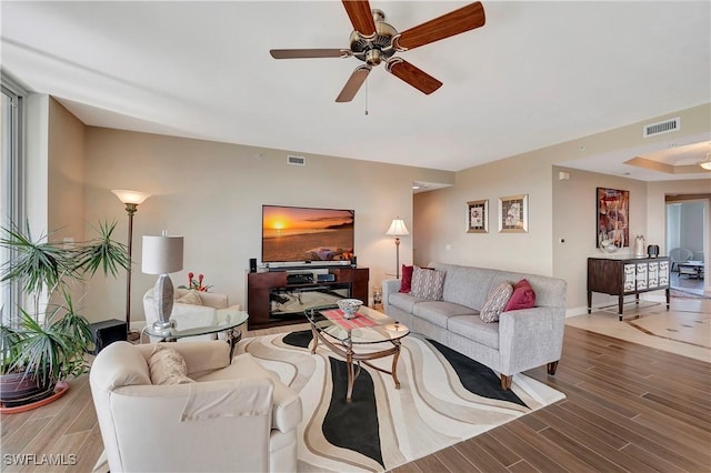 living room featuring ceiling fan and wood-type flooring