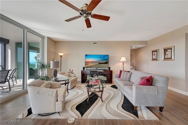 living room featuring ceiling fan and light hardwood / wood-style flooring