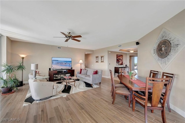 living room featuring ceiling fan and light hardwood / wood-style flooring