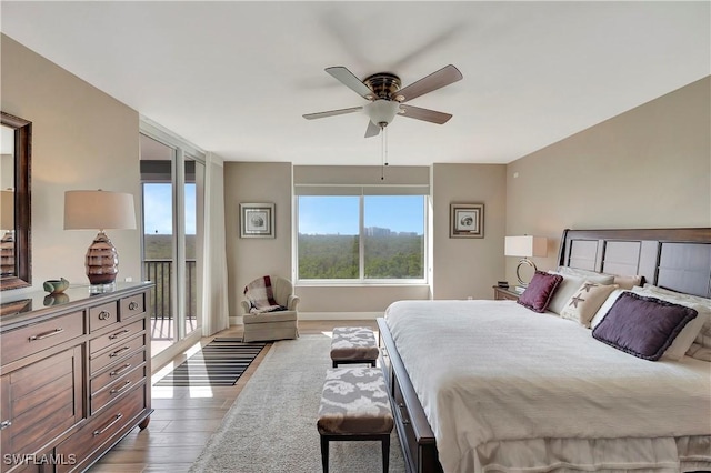 bedroom with access to exterior, ceiling fan, and dark wood-type flooring