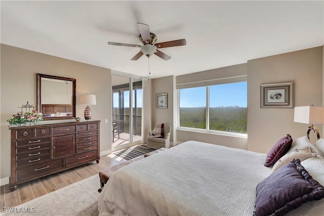 bedroom featuring access to exterior, ceiling fan, and light hardwood / wood-style floors