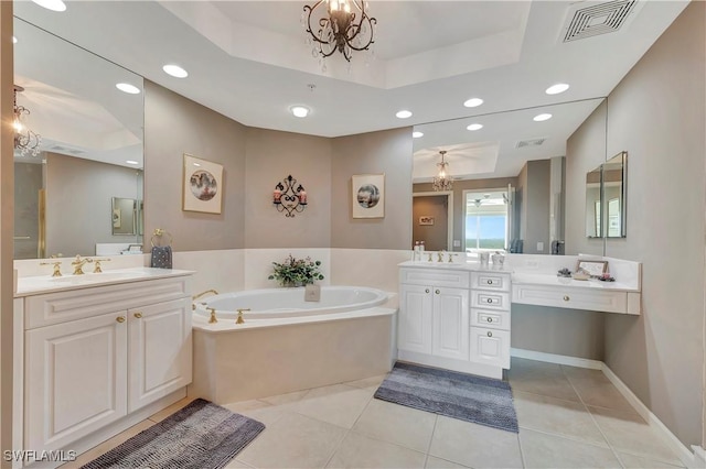 bathroom featuring vanity, a bath, an inviting chandelier, tile patterned floors, and a raised ceiling