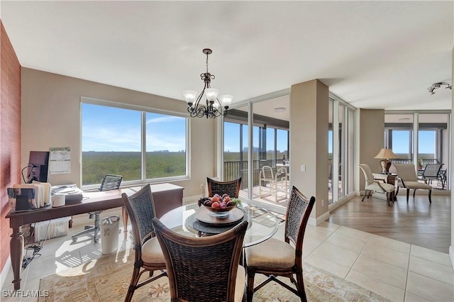 dining space featuring light hardwood / wood-style flooring and a notable chandelier