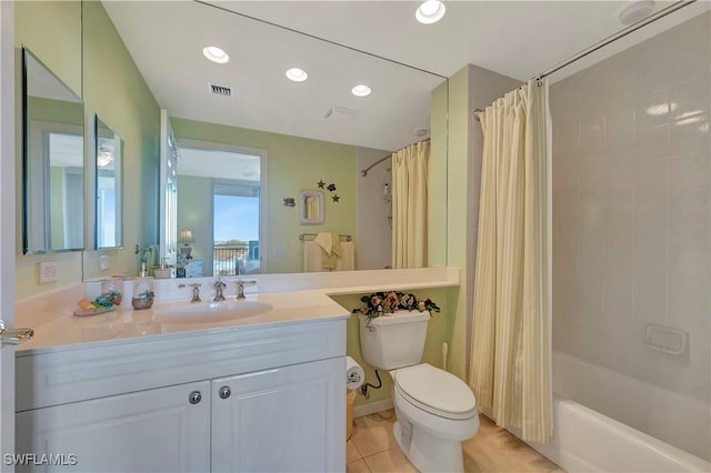 full bathroom featuring tile patterned flooring, vanity, toilet, and shower / bath combo with shower curtain