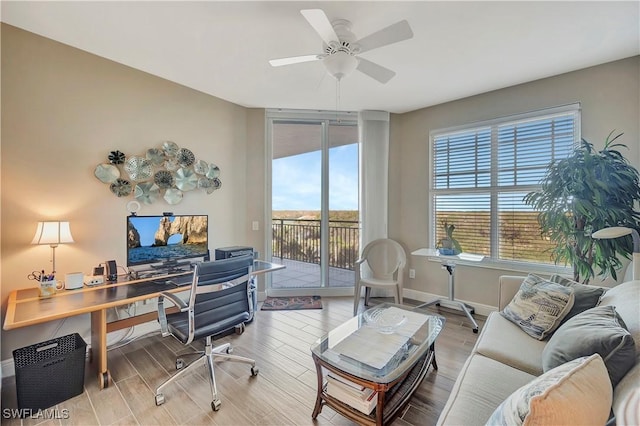 office area with ceiling fan and light hardwood / wood-style floors