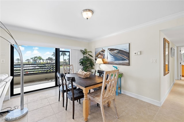 dining area featuring light tile patterned floors and crown molding