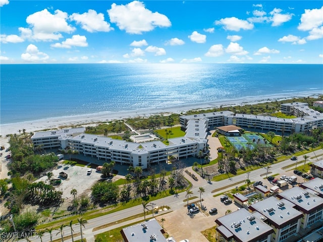 drone / aerial view featuring a water view and a view of the beach