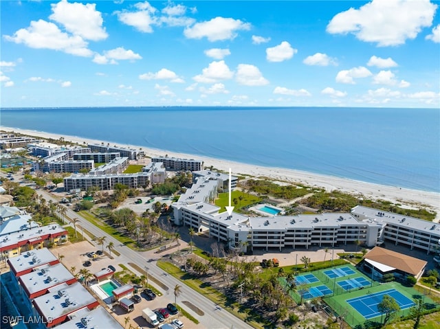 drone / aerial view with a water view and a beach view