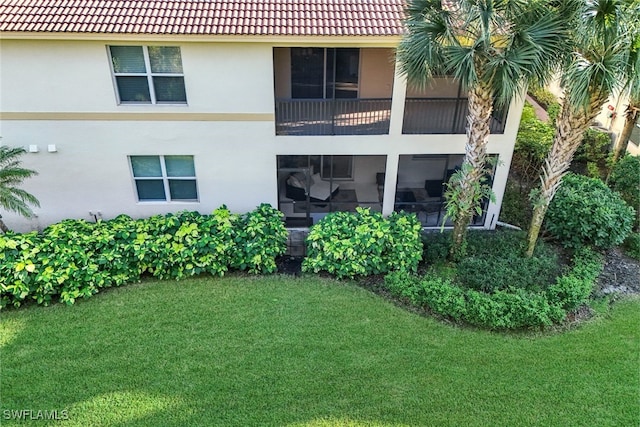 rear view of house featuring a yard