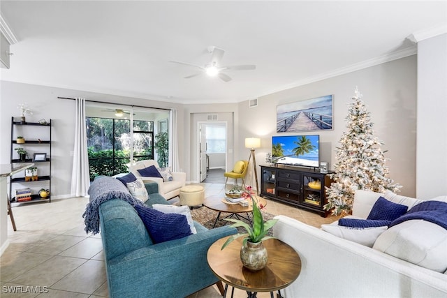 living room featuring light tile patterned floors, ceiling fan, and crown molding