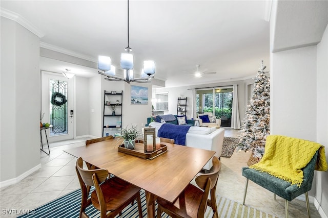 tiled dining room featuring ceiling fan with notable chandelier and crown molding