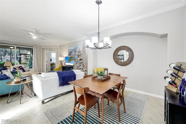 tiled dining space with ceiling fan with notable chandelier and ornamental molding