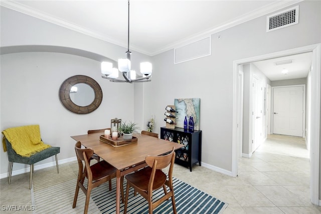 tiled dining room with crown molding and an inviting chandelier