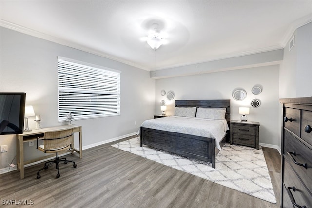 bedroom with crown molding and light hardwood / wood-style floors