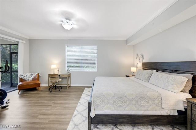 bedroom featuring access to exterior, crown molding, hardwood / wood-style floors, and ceiling fan