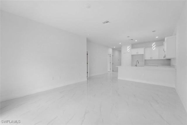 unfurnished living room with sink