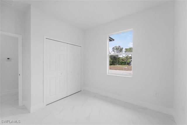 unfurnished bedroom with a closet