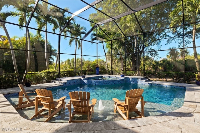 view of pool featuring pool water feature, glass enclosure, a patio area, and an in ground hot tub