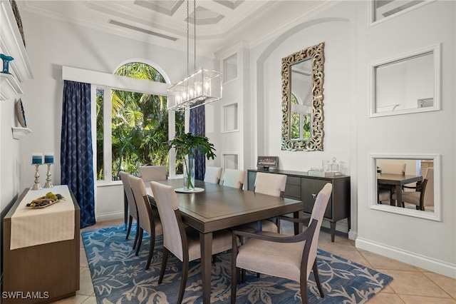 dining room with coffered ceiling, crown molding, light tile patterned floors, a notable chandelier, and a high ceiling