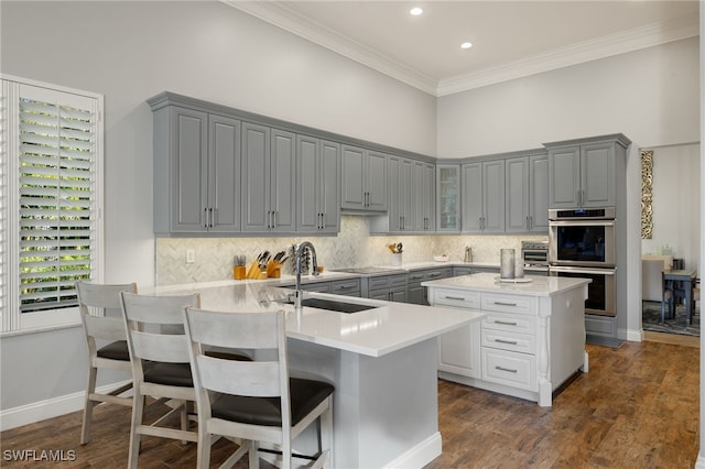 24221 Addison Place Ct, Bonita Springs, FL 34134 - kitchen featuring gray cabinets, stainless steel double oven, crown molding, light countertops, and decorative backsplash