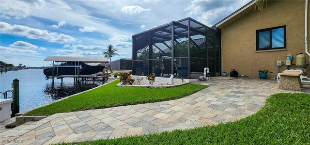 exterior space with a patio, a water view, a yard, and a lanai