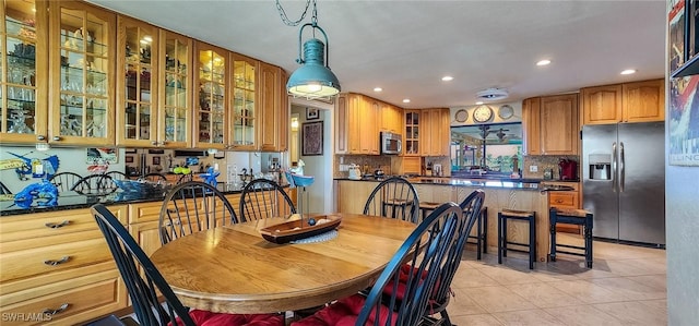 dining room with recessed lighting and light tile patterned flooring