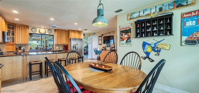 dining area featuring light tile patterned floors, baseboards, visible vents, and recessed lighting