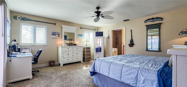 bedroom with visible vents, baseboards, light colored carpet, and ceiling fan