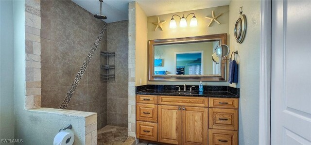 bathroom featuring walk in shower and vanity