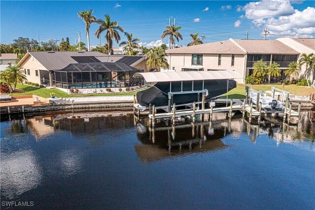 dock area featuring glass enclosure, a water view, and boat lift