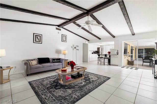 living room with vaulted ceiling with beams, light tile patterned floors, and ceiling fan