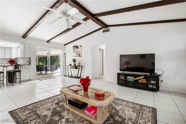 living room with lofted ceiling with beams, ceiling fan, and light tile patterned flooring