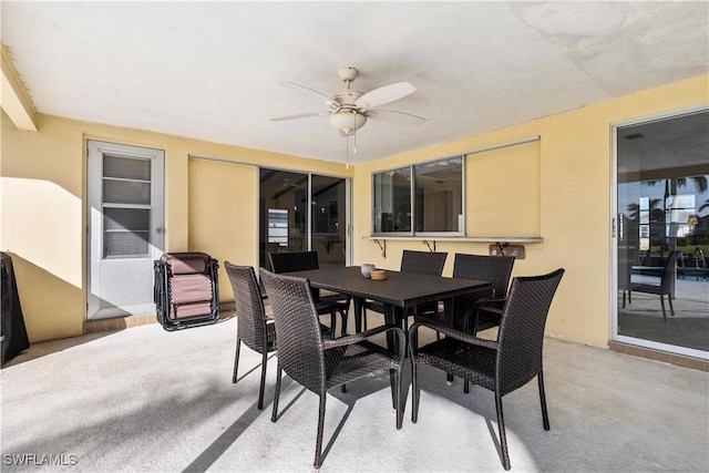 dining room with light carpet and ceiling fan