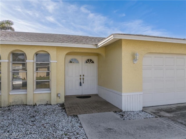 view of exterior entry featuring a garage