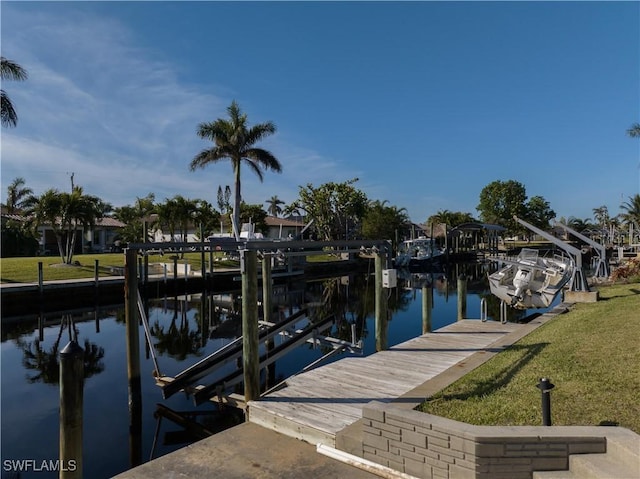 dock area with a water view and a lawn