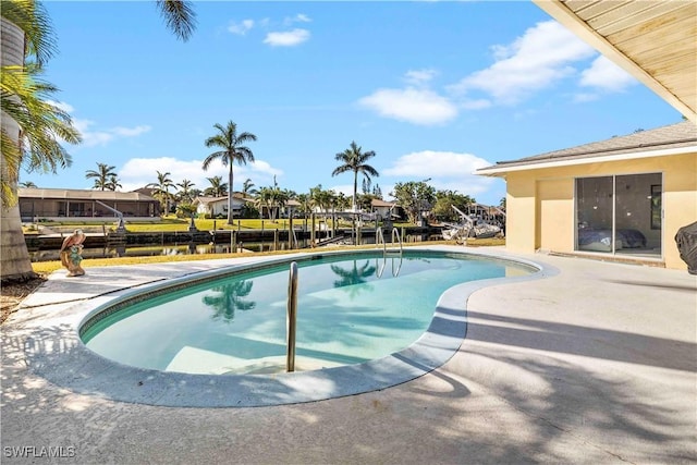 view of swimming pool with a water view