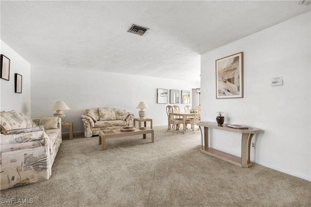 living room featuring light carpet and a textured ceiling