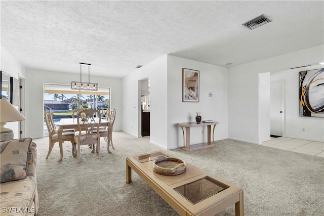 living room with light colored carpet and a textured ceiling