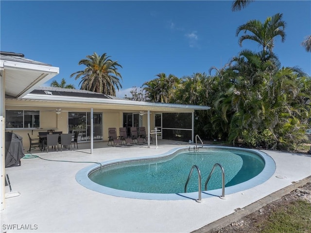 view of swimming pool with a patio