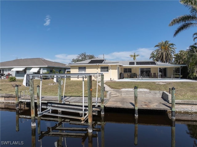 dock area with a patio and a water view